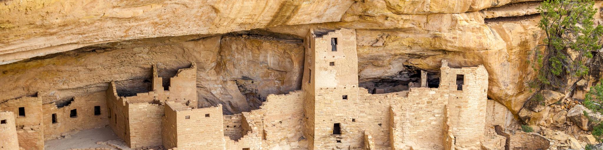 Sandy cliff dwellings nestled within the rockfaces at Mesa Verde National Park