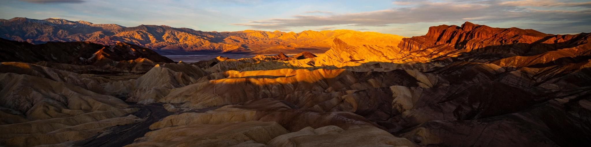 Sunrise in zabriskie point, Zabriskie Point, Death Valley National Park, with different colored mountains dotted across the desert
