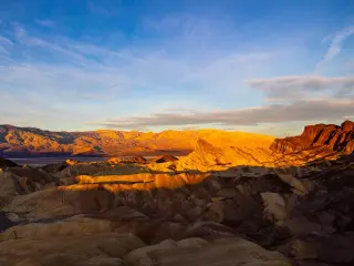 Sunrise in zabriskie point, Zabriskie Point, Death Valley National Park, with different colored mountains dotted across the desert