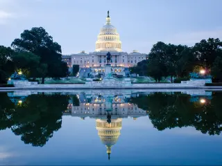 Washington DC, US Capitol Building in a cloudy sunrise with mirror reflection