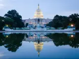 Washington DC, US Capitol Building in a cloudy sunrise with mirror reflection