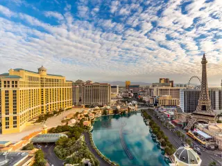 Aerial view of cityscape of Las Vegas Strip, dotted with hotels, amusements and landmarks including replica Eiffel Tower 
