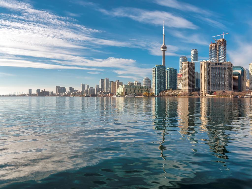 Toronto city skyline and reflection in the lake at sunset, Ontario, Canada.