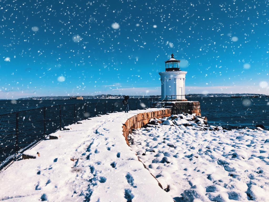 The Portland Breakwater Light (also called Bug Light) is a small lighthouse in South Portland, Maine,United States.The lighthouse winter view after snow with blue sky background.