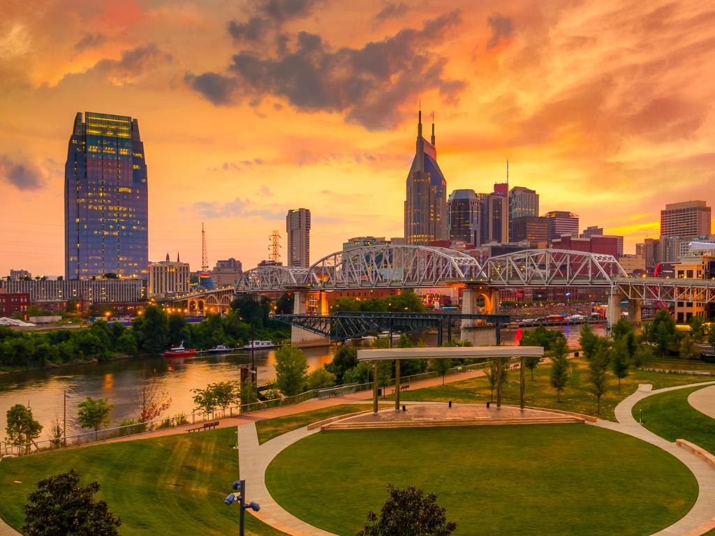 Nashville, Tennessee, USA with a beautiful view of the city at sunset with a green park in the foreground. 