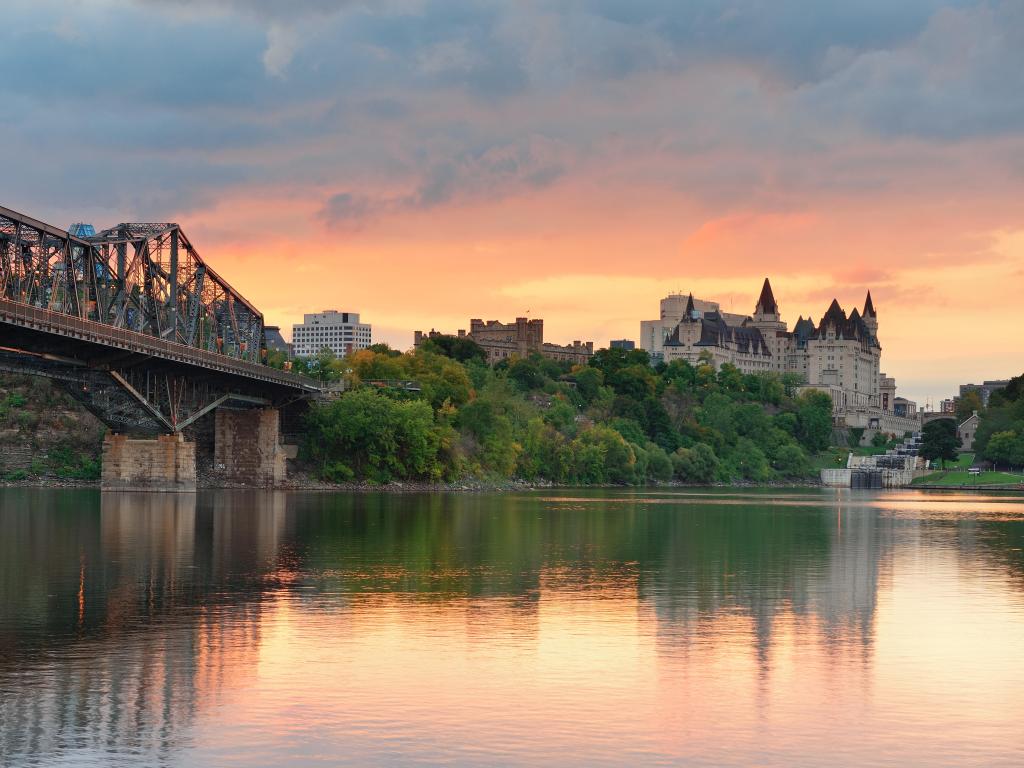 Ottawa city skyline at sunrise in the morning over river with urban historical buildings and colorful cloud