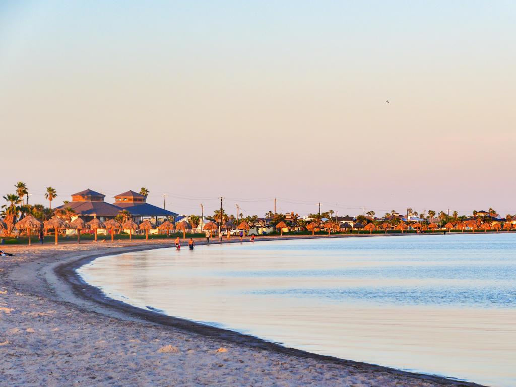 A quiet morning at the beach, tranquil sea with beach umbrellas in the background