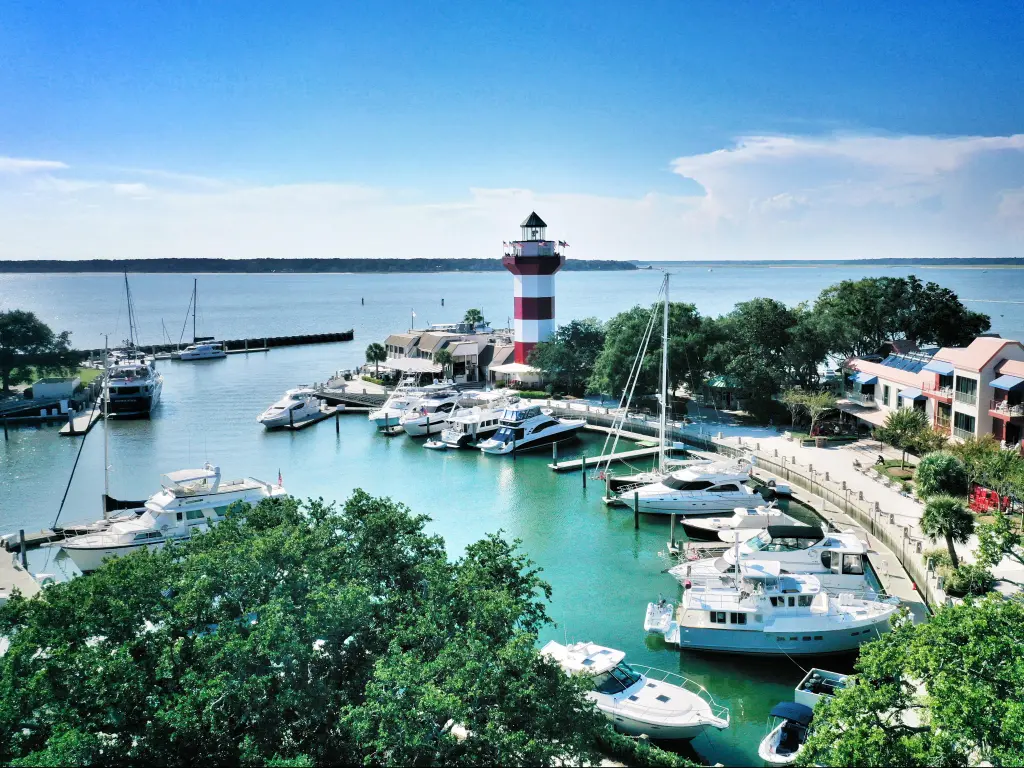 Aerial view of boats moored in the marina and a lighthouse on the pier in HARBOUR TOWN, HILTON HEAD ISLAND
