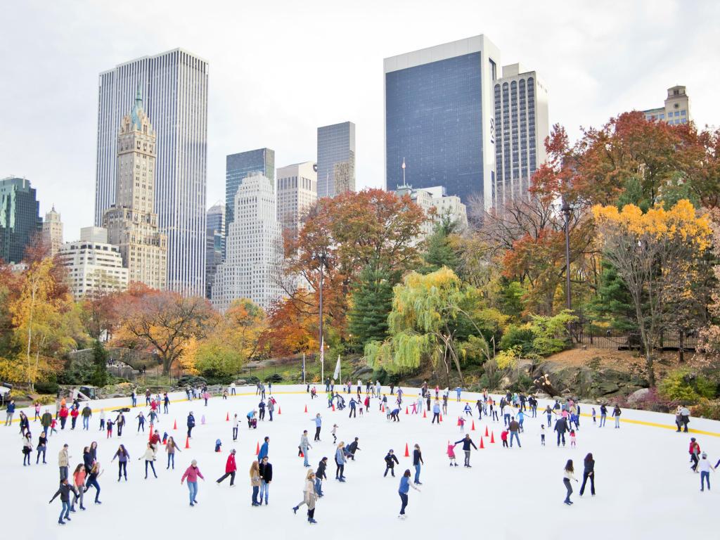 Ice skaters having fun in New York Central Park in fall