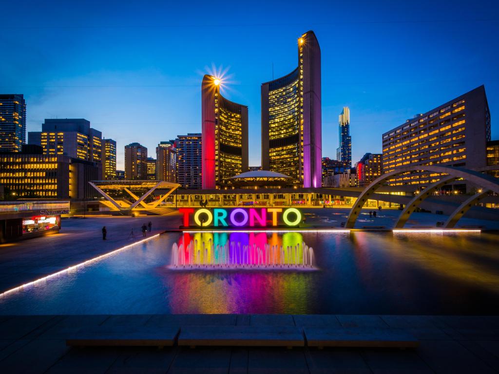 View of Nathan Phillips Square and Toronto Sign in downtown at night, in Toronto