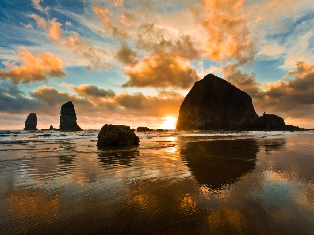 View out to sea at Cannon Beach, Oregon, with Haystack Rock standing in the sunset