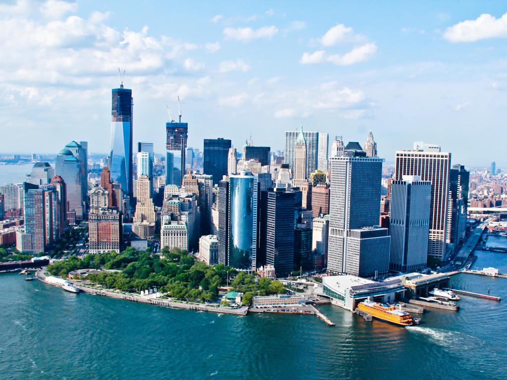 New York, USA with a city sky view surrounded by sea and taken on a sunny day with skyscrapers dominating the skyline.