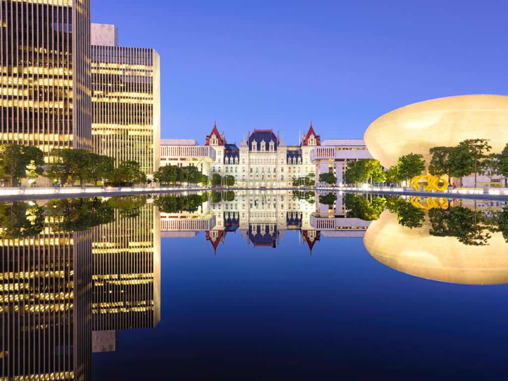 Empire State Plaza with the New York State Capitol Building and The Egg illuminated during the evening hours