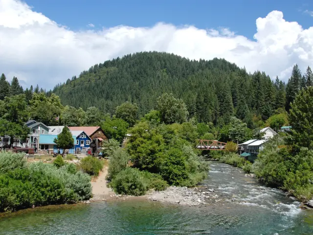 Yuba River flowing through the small town with forested mountains in the background