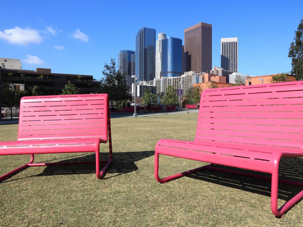 Two pink benches at Grand Park, LA with skyscrapers and blue sky in the background