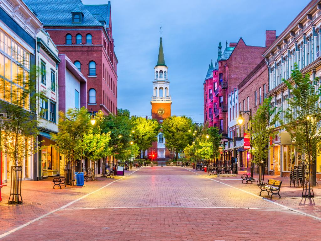 Burlington, Vermont, USA taken at at Church Street Marketplace with rows of shops and a central pavement lined with street lamps and trees at early evening. 