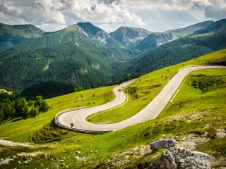 Winding Nockalm Road, Austria with green grass and cattle grazing 