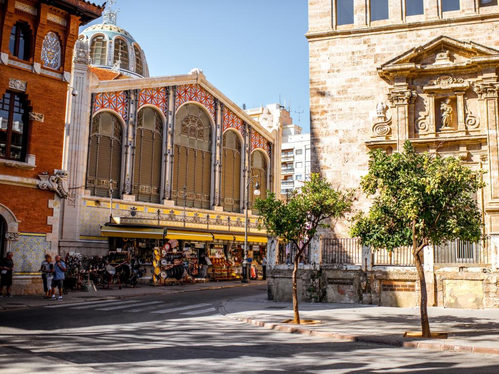 Street view with saint Joan church and famous food market Central in Valencia city, Spain