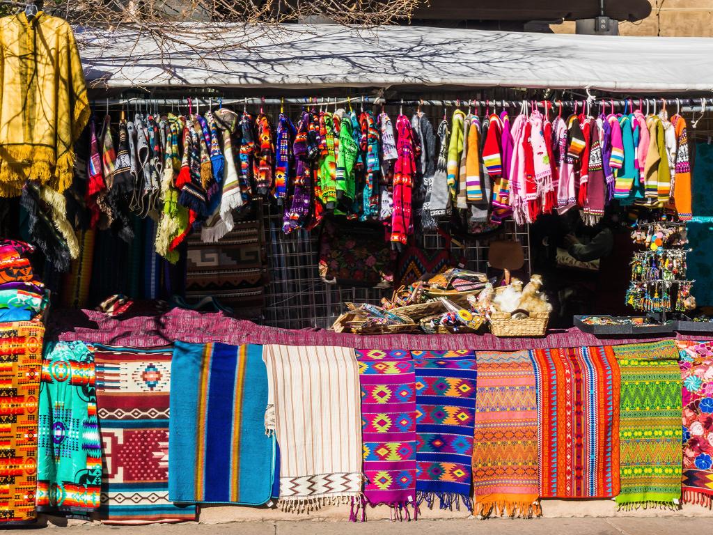 Market Scene in Santa Fe New Mexico with colorful clothes and rugs hung up