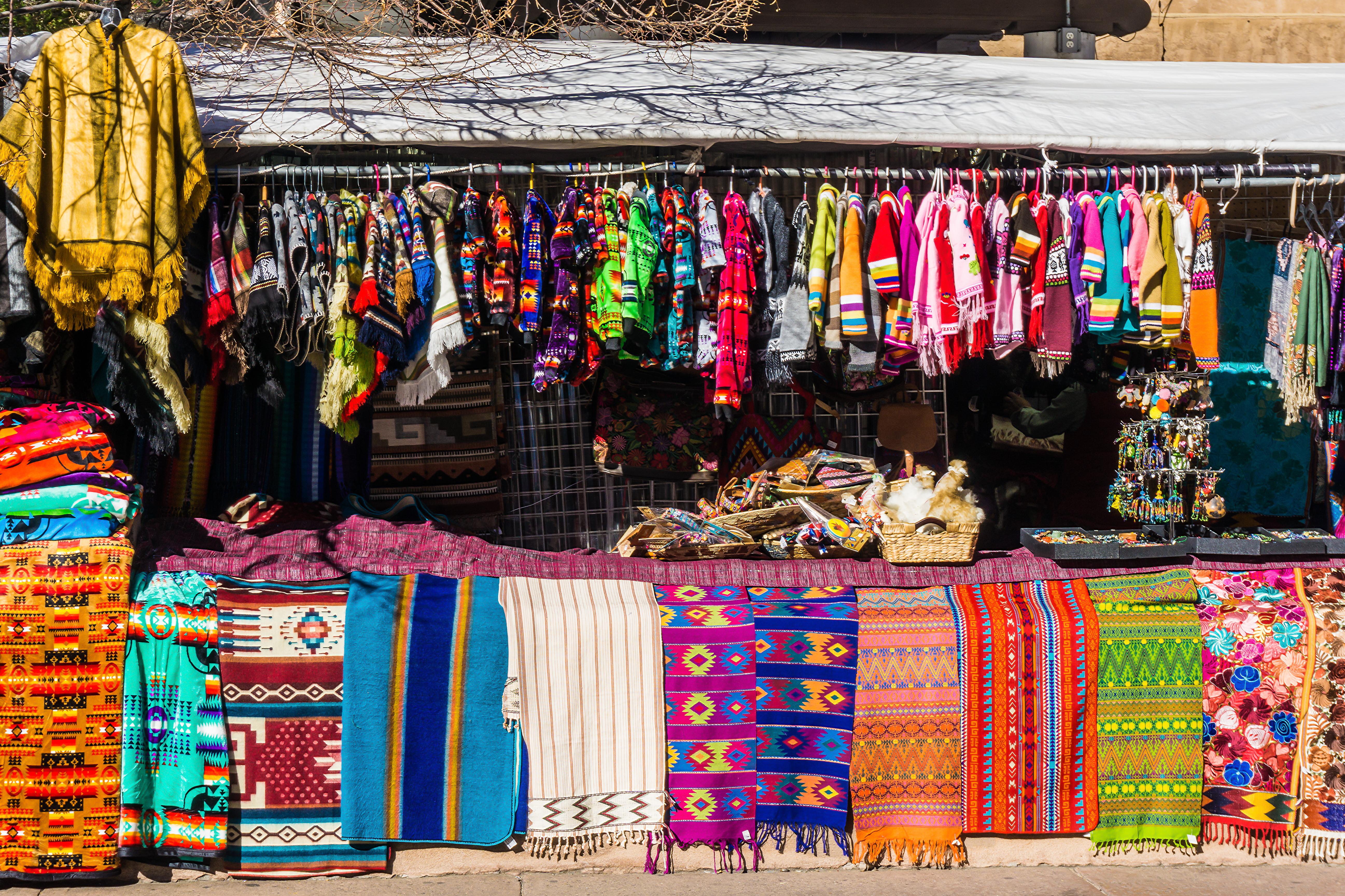 Market Scene in Santa Fe New Mexico with colorful clothes and rugs hung up