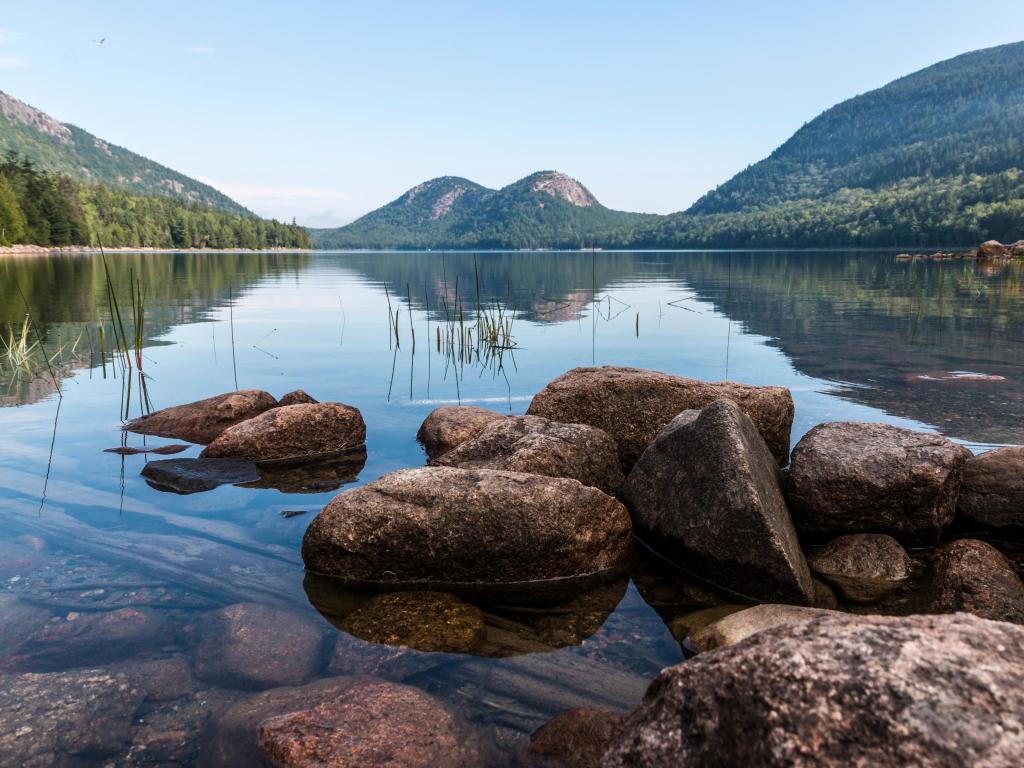 Acadia National Park, Maine, USA with a landscape view of the Bubbles from Jordan Pond on a clear sunny day with mountains in the distance.