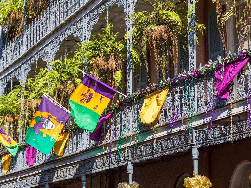 Ironwork galleries on the Streets of French Quarter decorated for Mardi Gras in New Orleans, Louisiana