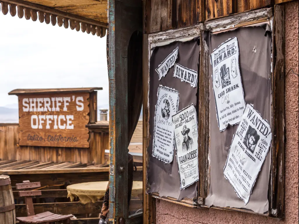 Calico is a ghost town in San Bernardino County, California, United States. The photo depicts wanted signs with the Sheriff's Office in the background.
