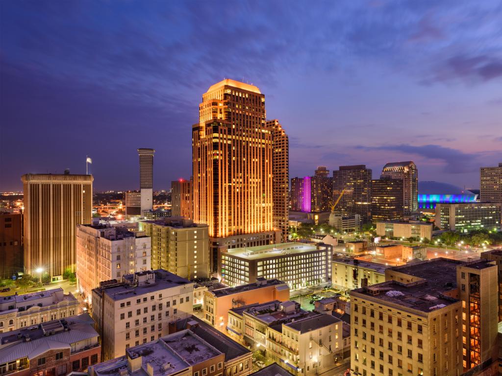 New Orleans, Louisiana, USA with the city skyline in the foreground and taken at night.