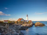 The Portland Head Light in Portland, Maine, USA, on a sunny day with blue skies.