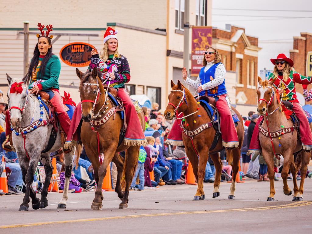 Women riding horses during Oklahoma Christmas Parade held every December. 