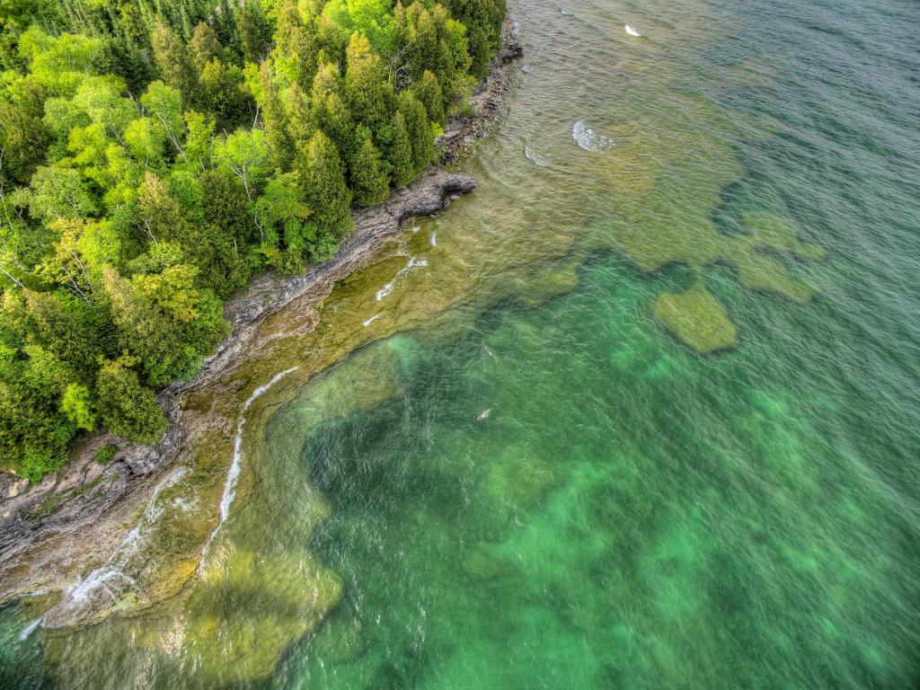 Whitefish Lake State Park, Wisconsin, USA taken as an aerial shot looking down to the clear water and dense woodland of the park.