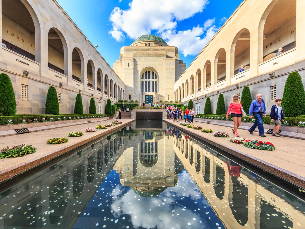 People visiting the Australian War Memorial in Canberra under a blue sky