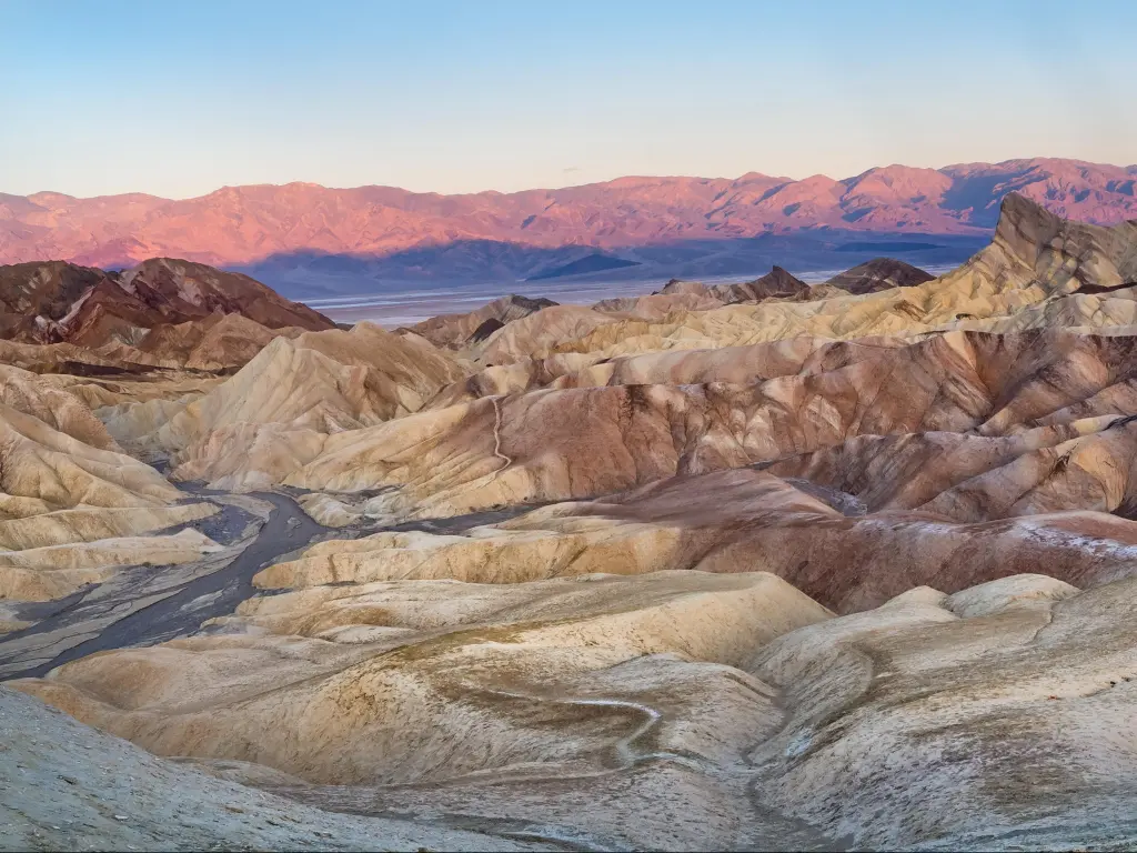 Death Valley National Park, California, United States showing Zabriskie Point in the foreground with mountains in the distance and a clear sky.