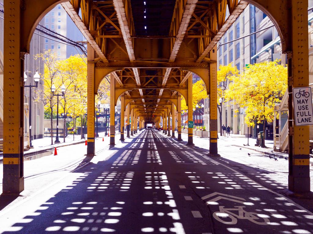 Metal bridge in Chicago, with shadows cast on the ground below