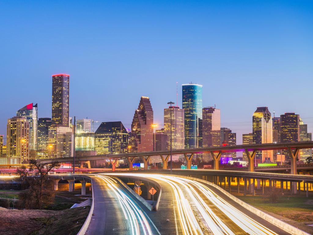 Houston, Texas, USA downtown city skyline and highway at dusk.