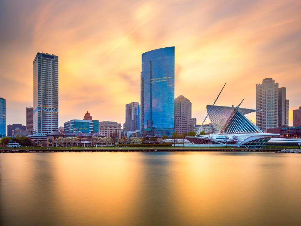 Milwaukee, Wisconsin, USA downtown city skyline on Lake Michigan at twilight, with a soft light in the sky.