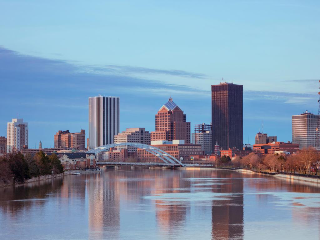 Rochester, New York, USA with the city skyline in the distance and water in the foreground.