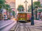 Bright lights at twilight of downtown New Orleans with streetcar in the foreground