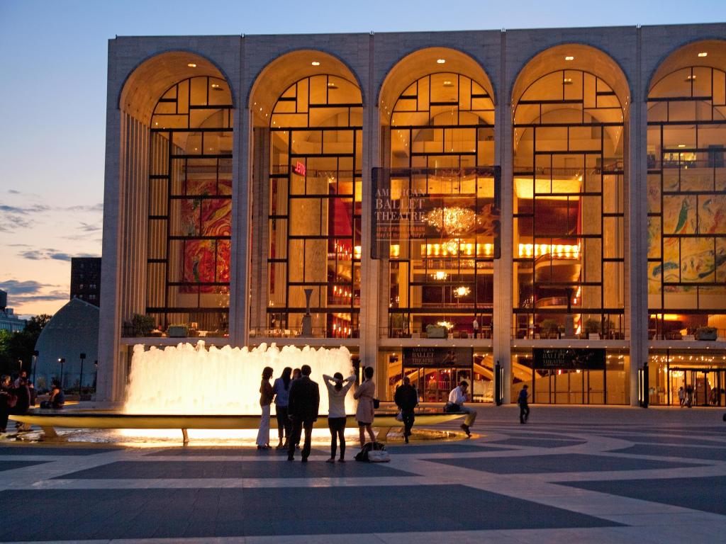 Lincoln Center for the Performing Arts at dusk, with crowds in front of water fountains 
