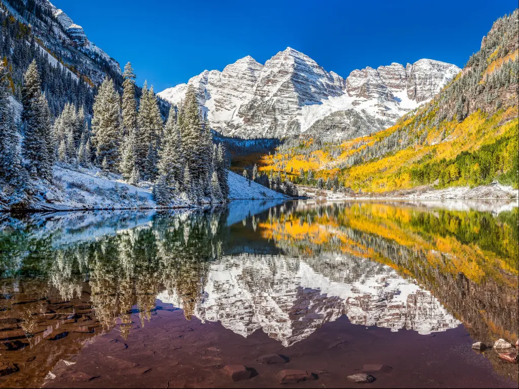 Winter and fall foliage at Maroon Bells, Aspen, Colorado. Photo is taken in the Rocky Mountain National Park on a clear day with blue skies.