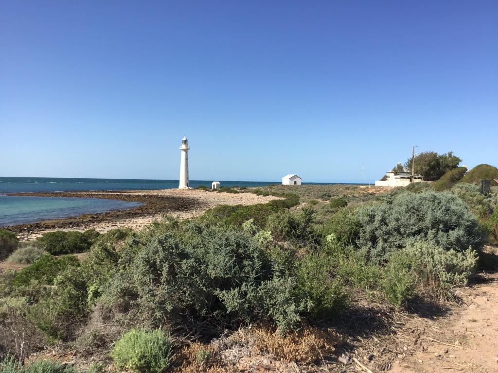 Famous lighthouse on the beach on a sunny day with blue skies