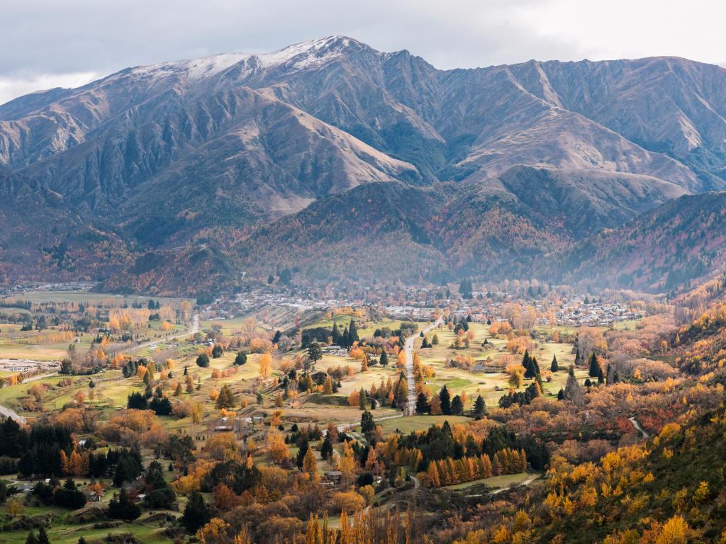 Colorful autumn in Arrowtown with large mountains in the background