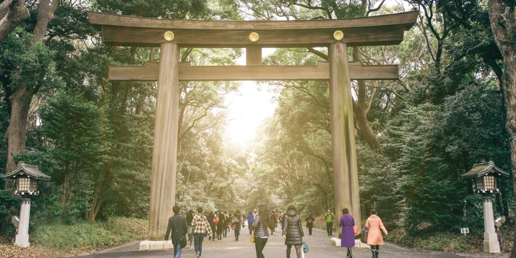 Visitors walking through the torii gate of the Meiji Shrine, Tokyo 