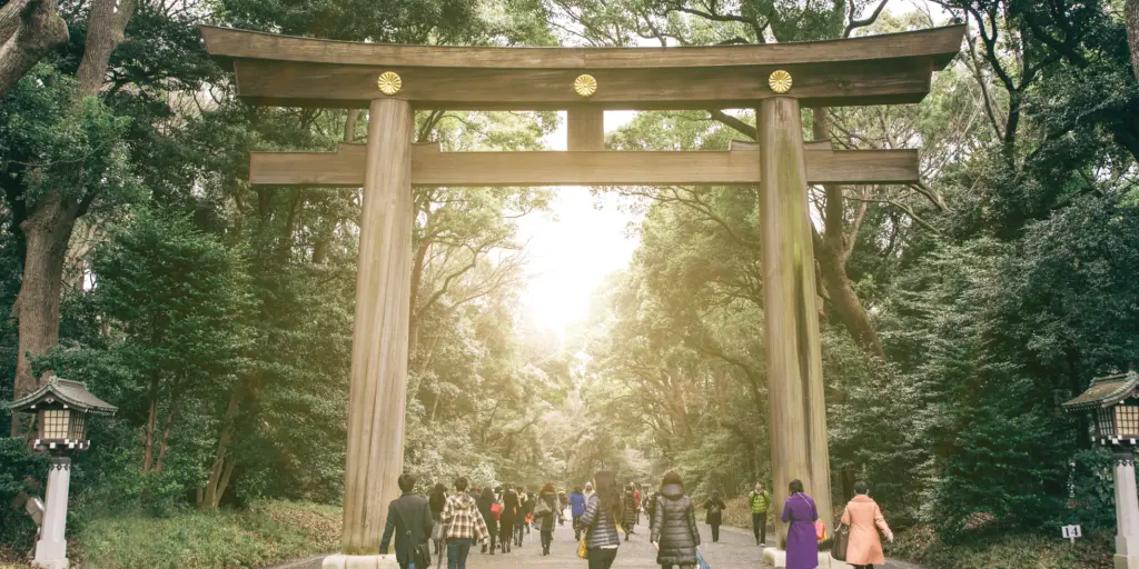 Visitors walking through the torii gate of the Meiji Shrine, Tokyo 