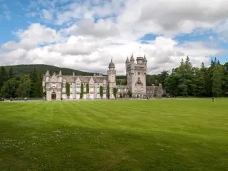 View of the Royal Balmoral Castle and lush green grounds and landscape, Scotland