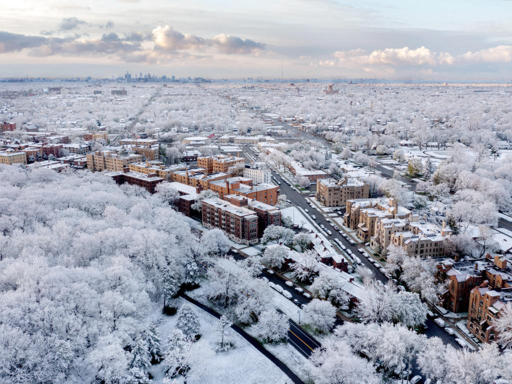 Aerial view of snow and ice-covered Detroit in the depths of winter, with downtown skyline in the distance