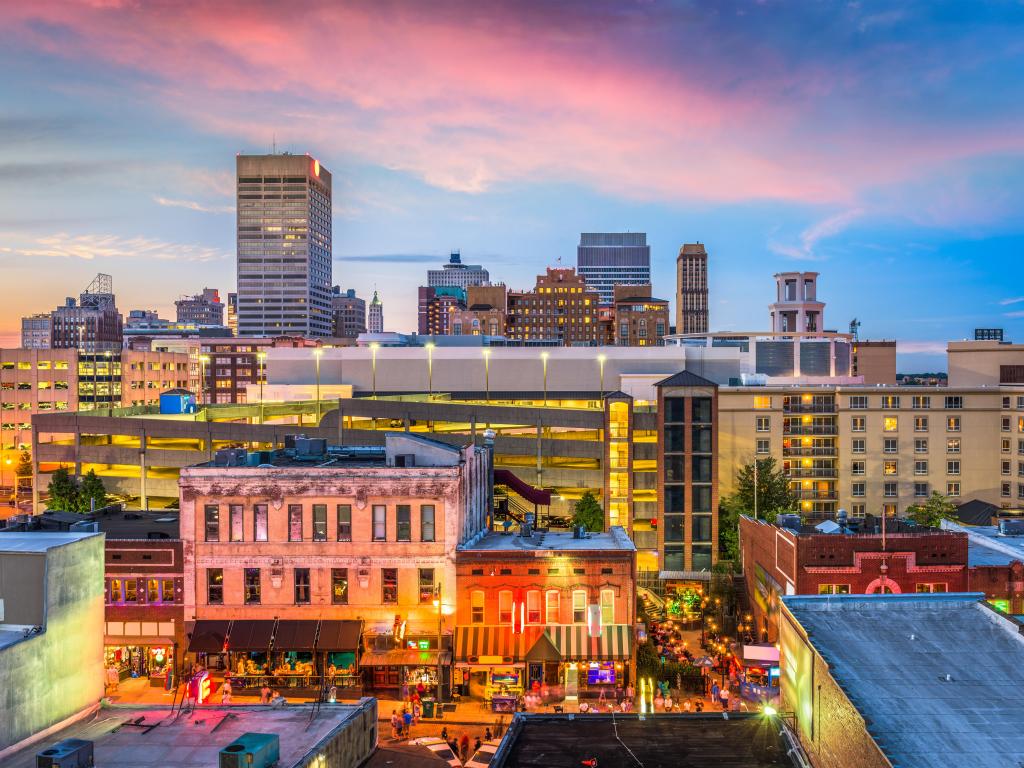 Memphis, Tennessee, USA downtown skyline. Bright city lights as the sun sets.