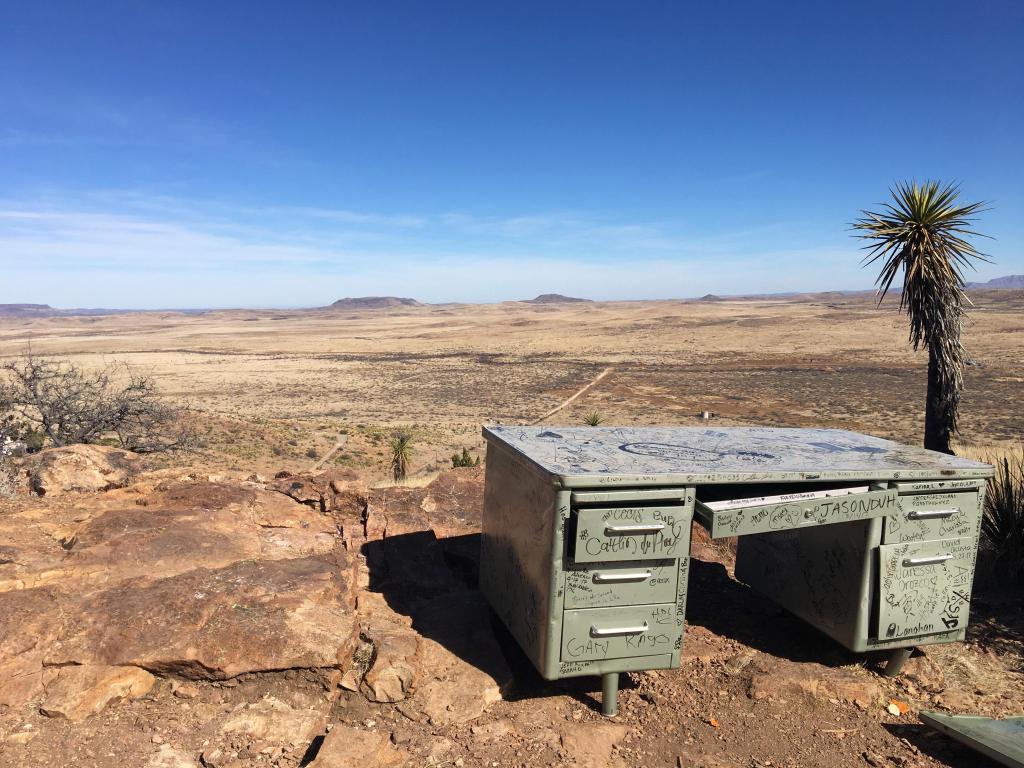Close up view of abandoned teacher desk with expansive Alpine desert view in the background