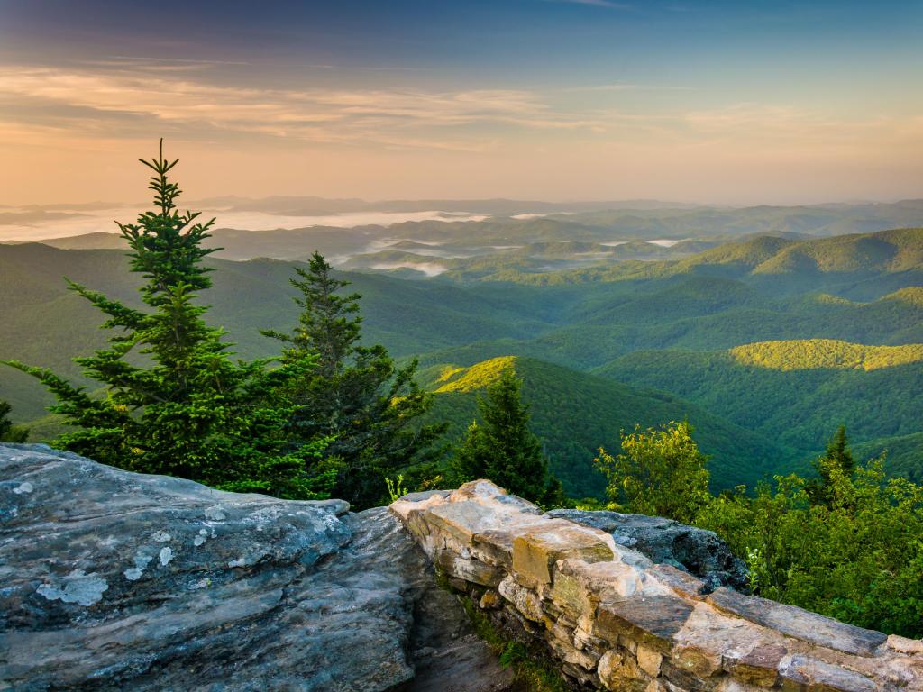 Blue Ridge Parkway, North Carolina, USA with a morning view from Devil's Courthouse, rocks in the foreground and tree covered mountains in the distance. 