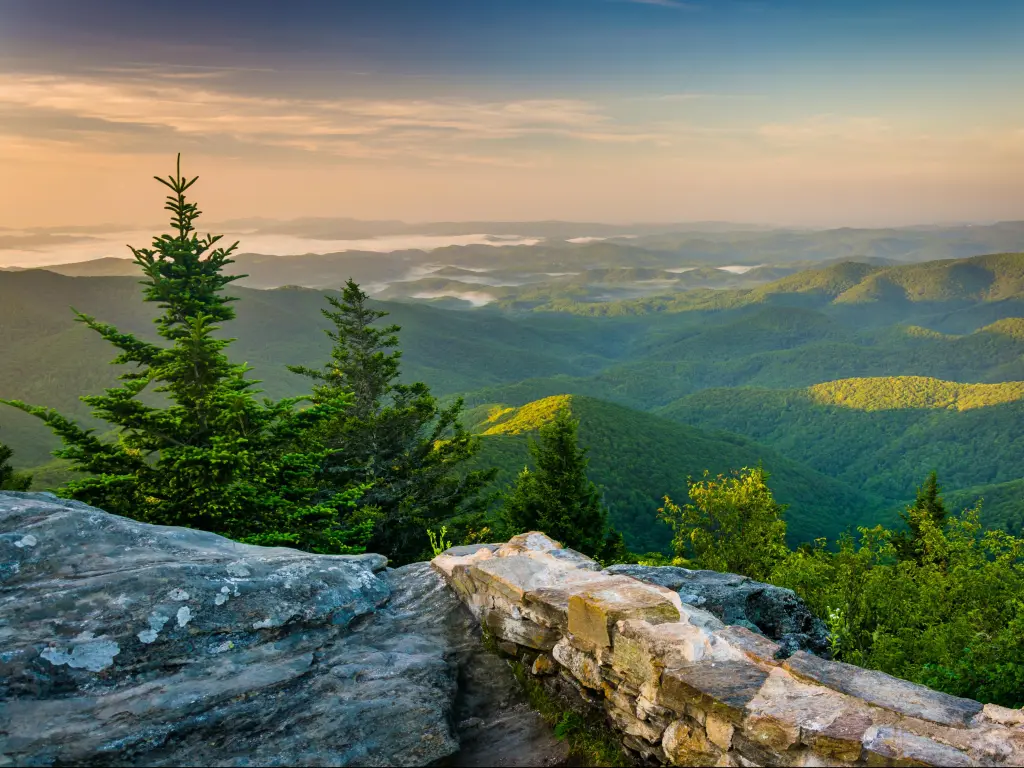 Blue Ridge Parkway, North Carolina, USA with a morning view from Devil's Courthouse, rocks in the foreground and tree covered mountains in the distance. 